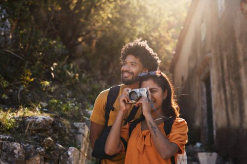 woman photographing through camera by boyfriend - travel stock pictures, royalty-free photos & images