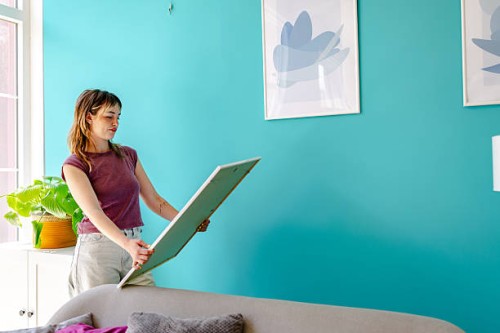 woman planning wall decor at home - home decoration stock pictures, royalty-free photos & images