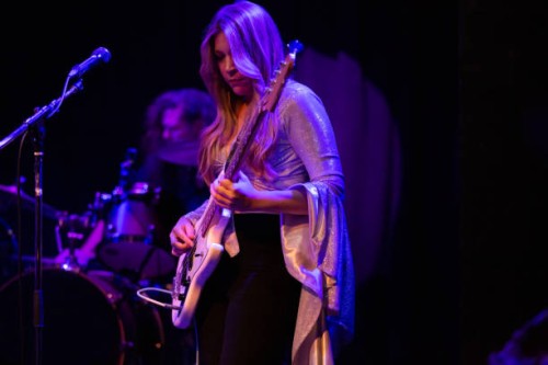 woman playing bass guitar onstage with band - concert stock pictures, royalty-free photos & images