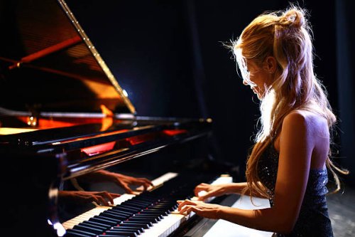 woman playing piano in a concert. - concert stock pictures, royalty-free photos & images
