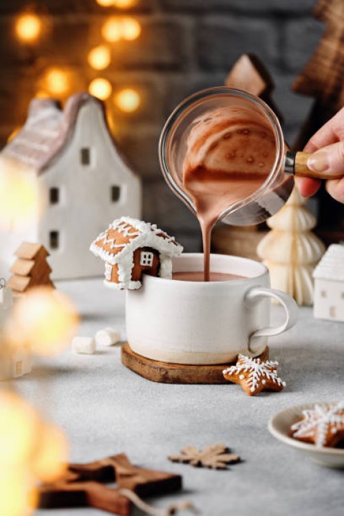 woman pouring hot chocolate in mug on table. - home decoration stock pictures, royalty-free photos & images