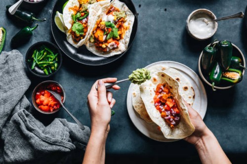 woman preparing tasty vegan tacos - food stock pictures, royalty-free photos & images