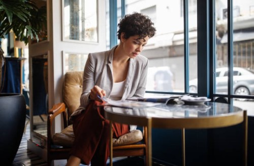 woman reading a magazine at cafe - fashion stock pictures, royalty-free photos & images