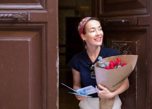 woman receiving a flower bouquet with greeting card - fashion stock pictures, royalty-free photos & images