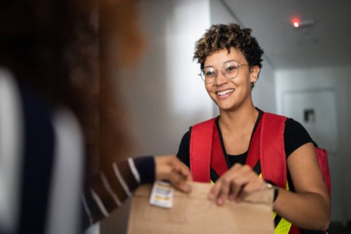 woman receiving delivery at home - food stock pictures, royalty-free photos & images