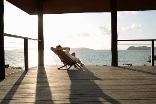 woman relaxing in deck chair on veranda. - travel stock pictures, royalty-free photos & images