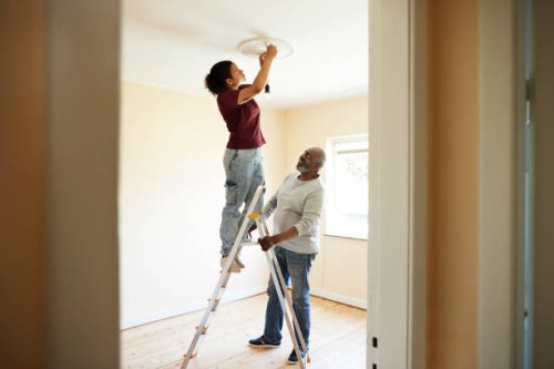 woman renovating home with father - home decoration stock pictures, royalty-free photos & images
