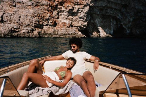 woman resting by boyfriend sitting in motorboat - travel stock pictures, royalty-free photos & images