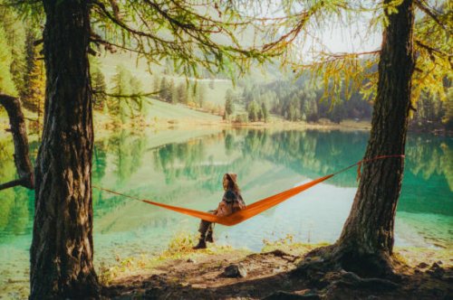 woman resting in hammock on the background of the lake in alps - travel stock pictures, royalty-free photos & images
