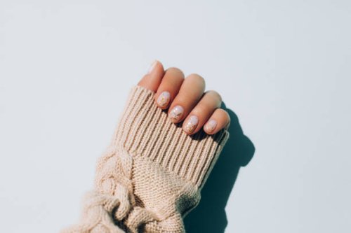woman's hand in warm sweater showing manicure - nails art stock pictures, royalty-free photos & images