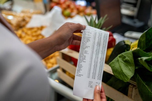 woman shopping at a supermarket and checking her receipt - food stock pictures, royalty-free photos & images