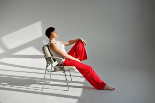 woman sitting in a modern chair - fashion stock pictures, royalty-free photos & images