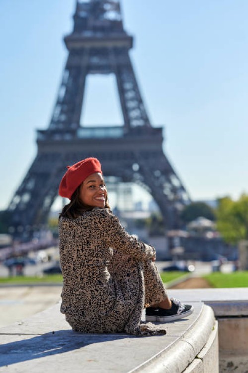 woman sitting in front of the eiffel tower - fashion stock pictures, royalty-free photos & images