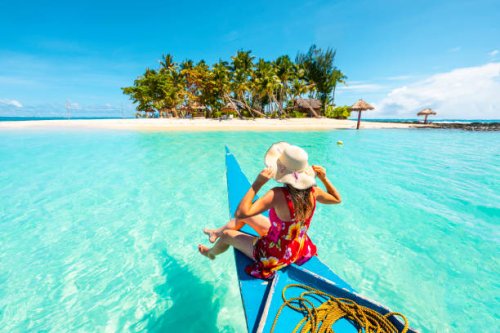 woman sitting on bangka boat approaching a tropical island - travel stock pictures, royalty-free photos & images