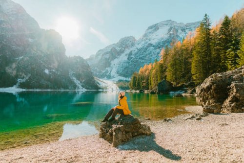 woman sitting on the background of lago di braies in winter - travel stock pictures, royalty-free photos & images