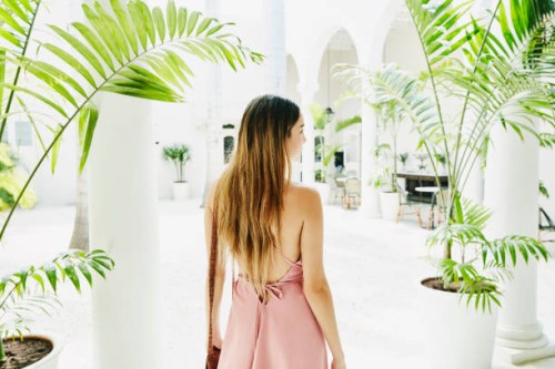 woman standing in courtyard of luxury shopping boutique - fashion stock pictures, royalty-free photos & images