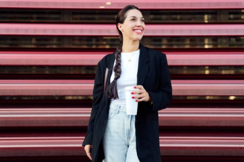woman standing on the street and drinking coffee - junk food stock pictures, royalty-free photos & images