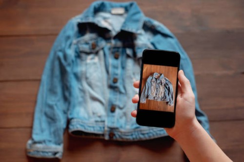 woman taking photo of denim shirt on smartphone - fashion stock pictures, royalty-free photos & images