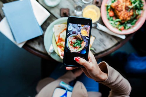 woman taking pics of food using smartphone - food stock pictures, royalty-free photos & images