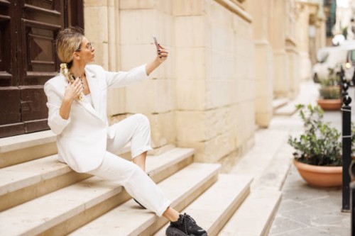 woman taking selfie on staircase - fashion stock pictures, royalty-free photos & images