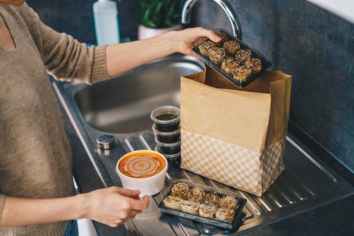woman unpacking takeaway food delivery - junk food stock pictures, royalty-free photos & images