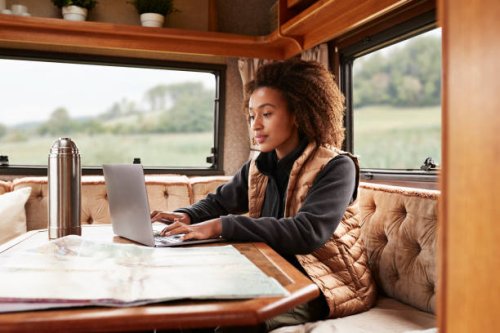 woman using laptop in camper van - travel stock-fotos und bilder