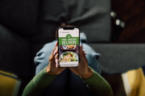 woman using meal delivery mobile app - junk food stock pictures, royalty-free photos & images