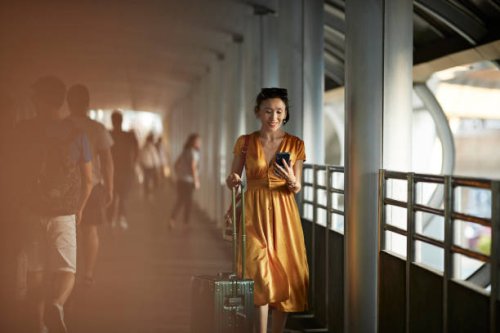 woman using mobile phone at railroad station - travel stock pictures, royalty-free photos & images