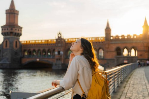 woman walking in berlin at sunset near oberbaumbrucke bridge - travel stock pictures, royalty-free photos & images