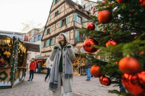 woman walking near the christmas tree in city centre - travel stock pictures, royalty-free photos & images