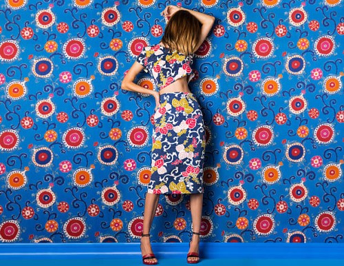 woman wearing print dress against print background - fashion stock pictures, royalty-free photos & images