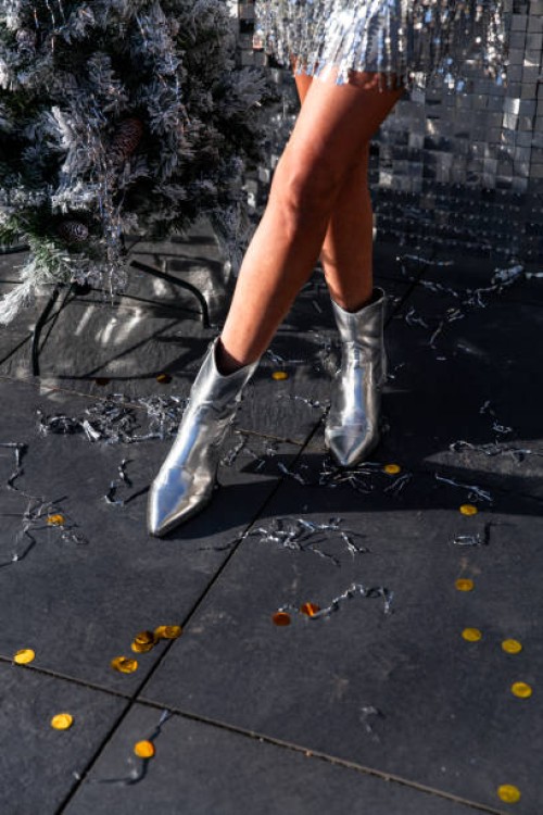 woman wearing silver party glitter dress for celebrating new year's eve silvester disco - fashion stock pictures, royalty-free photos & images