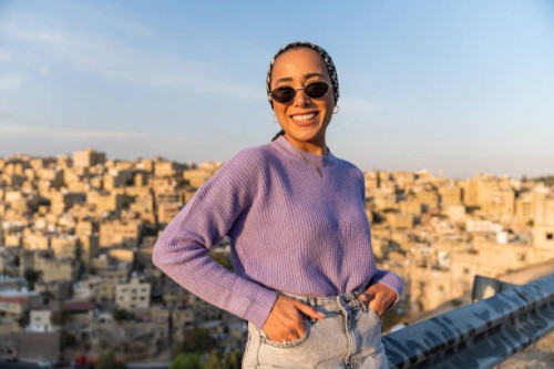 woman wearing sunglasses standing outside smiling - fashion stock pictures, royalty-free photos & images
