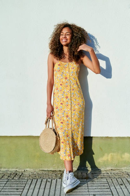woman with afro hair in front of white wall - fashion stock pictures, royalty-free photos & images