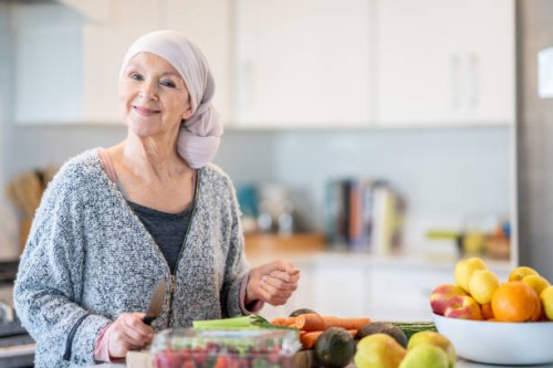 woman with cancer cooks a health meal - food stock pictures, royalty-free photos & images