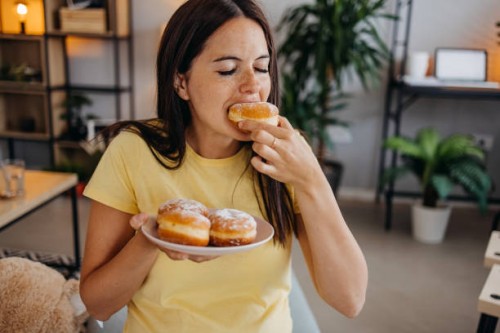 woman with donuts - junk food stock pictures, royalty-free photos & images