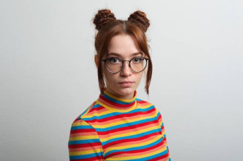 woman with freckles ,glasses and chignon - hairstyle stock-fotos und bilder