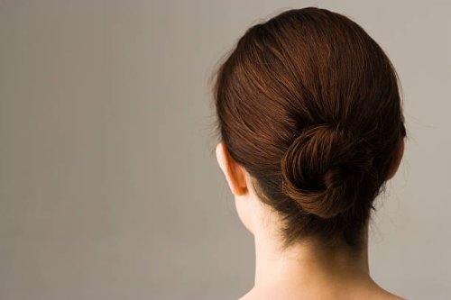 woman with hair arranged in chignon, rear view - hairstyle stock pictures, royalty-free photos & images