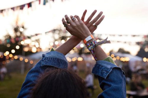 woman with hands raised dancing at music festival - concert stock pictures, royalty-free photos & images