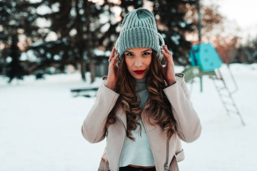 woman with headphones listening to music on a snowy winter day - fashion stock pictures, royalty-free photos & images