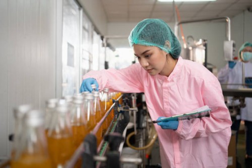 woman working in a food processing factory warehouse - food fotografías e imágenes de stock