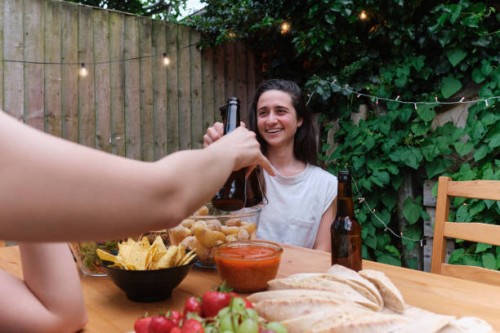 women cheering with beers at backyard party - garden decoration photos et images de collection