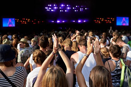 women clapping hands at large concert - concert stock pictures, royalty-free photos & images
