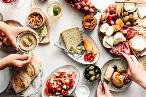 women eating fresh mediterranean platter on table - food stock pictures, royalty-free photos & images