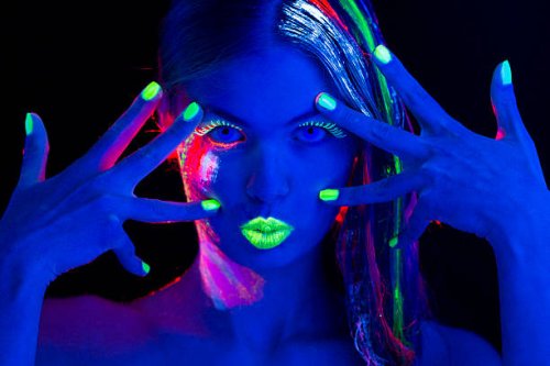 women portrait with glowing multi colored makeup in black light - nails art stock pictures, royalty-free photos & images