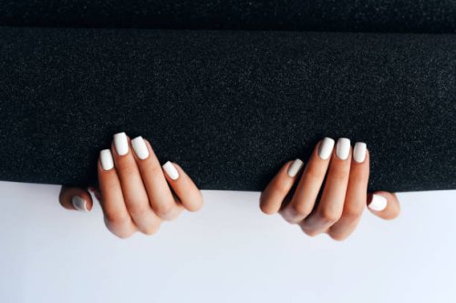 women's hands with white manicure on a black and white background. manicurist. nail care. nail polish. - nails art stock pictures, royalty-free photos & images