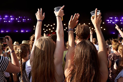 women with raised hands holding beer at concert - concert stock pictures, royalty-free photos & images