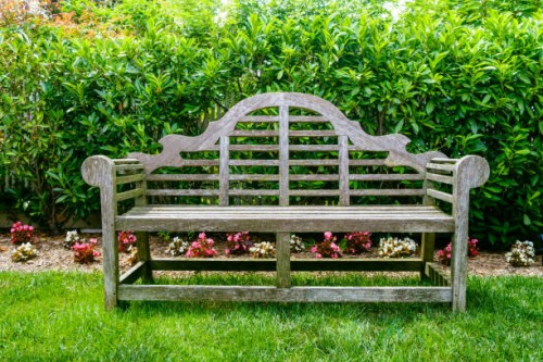 wood bench in garden - garden decoration stockfoto's en -beelden