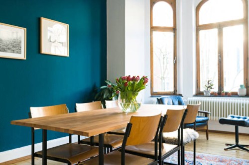 wooden table and chairs with large window front in modern living room in stylish apartment - home decoration stock pictures, royalty-free photos & images