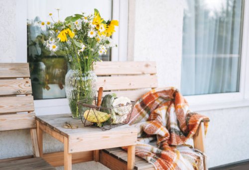 wooden table with wildflowers in vase and vegetables squash in basket in the backyard of house - garden decoration stock pictures, royalty-free photos & images